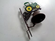 A cast iron tractor wall bracket with bell