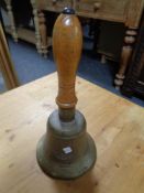 A brass wooden handled hand bell