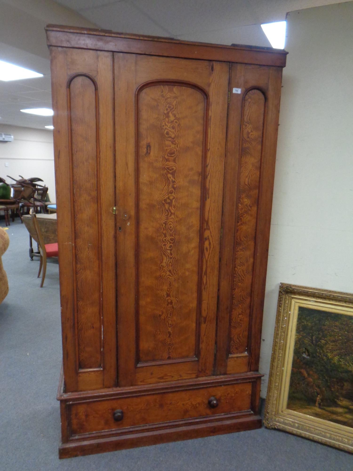 An antique pine single door wardrobe fitted drawer beneath,