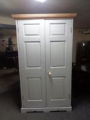 An antique pine painted double door wardrobe