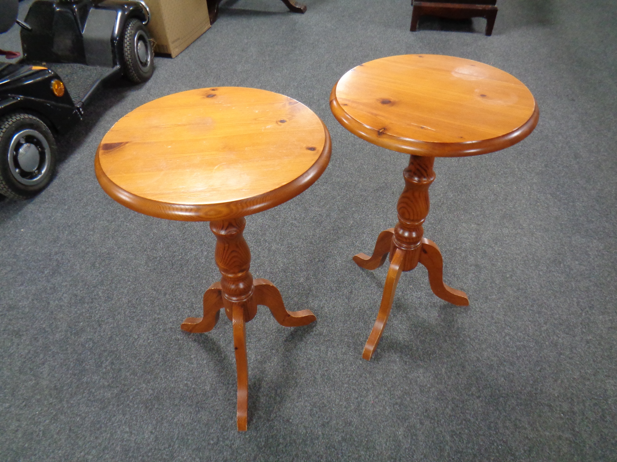 A pair of pine pedestal wine tables