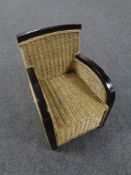 A wood framed wicker child's armchair