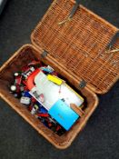 A large wicker hamper containing a quantity of play-worn die cast and plastic vehicles together