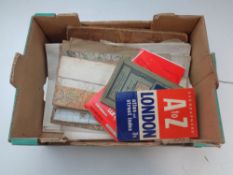 A box of folded ordinance survey maps, London street atlas,