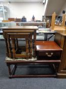 A nest of three tables together with a telephone table in an oak finish