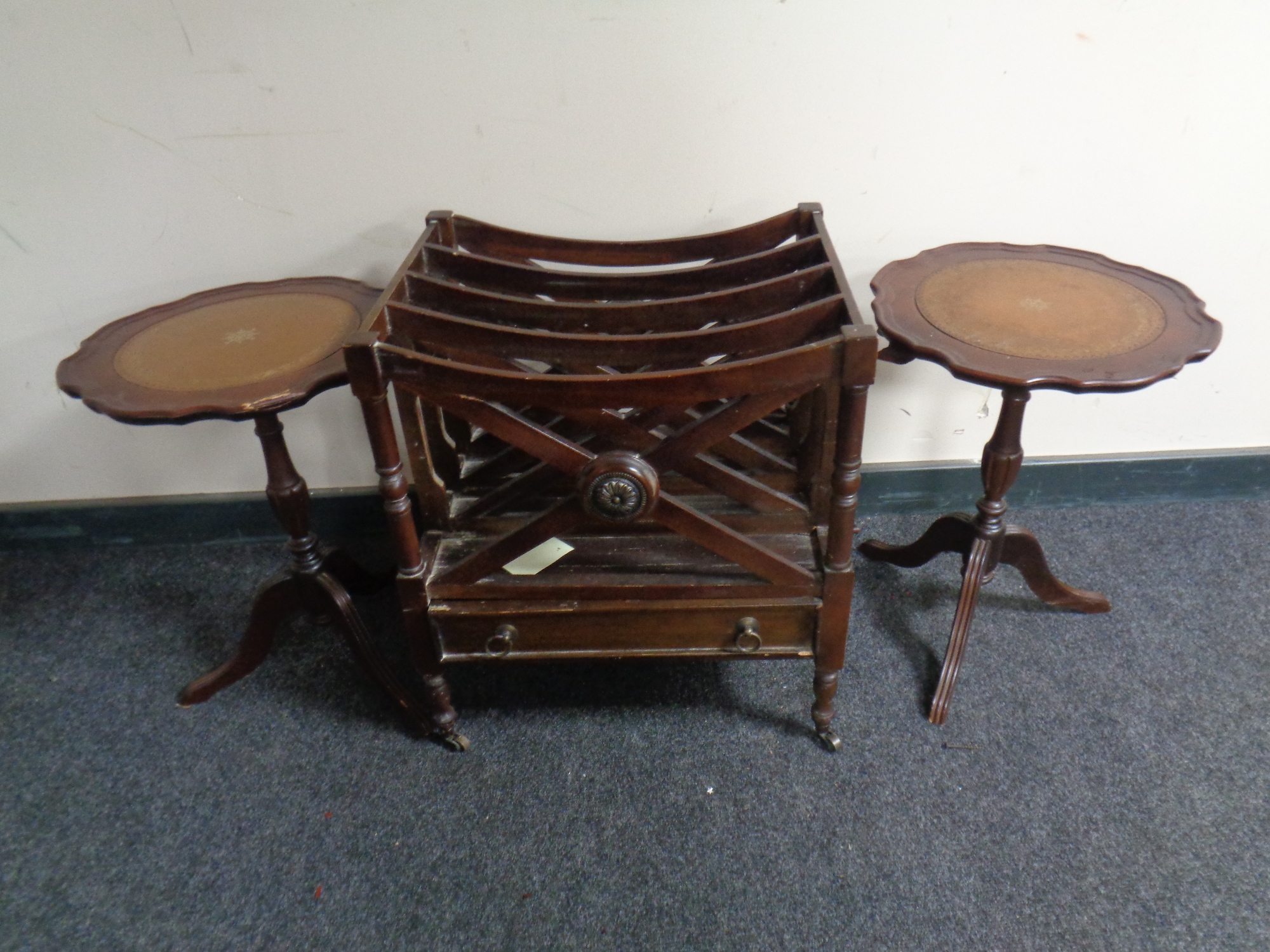 A pair of mahogany wine tables with leather inserts together with a Canterbury on brass castors