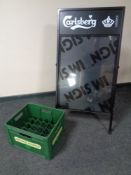 A Carlsberg A-Frame advertising board together with two plastic beer crates,