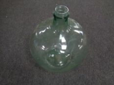 An antique green glass carboy