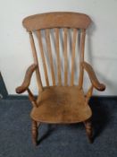 An antique elm and beech high back kitchen armchair