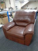 A brown leather manual reclining armchair
