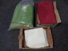 Two boxes containing vintage quilts and linen