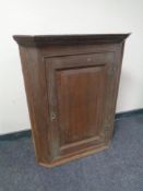 A 19th century oak hanging corner cupboard