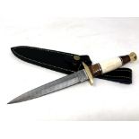 A commando style knife with Damascus steel blade, camel bone,