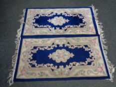 Two Chinese fringed rugs on blue ground