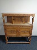 A 20th century stripped oak carved buffet back sideboard