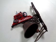 A cast iron tractor wall bracket with bell