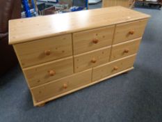 A pine effect eight drawer chest
