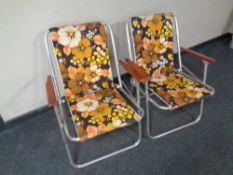 A pair of 20th century folding tubular metal deck chairs upholstered in a floral fabric
