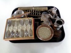 A tray containing assorted plated wares to include cased teaspoons, toast rack,