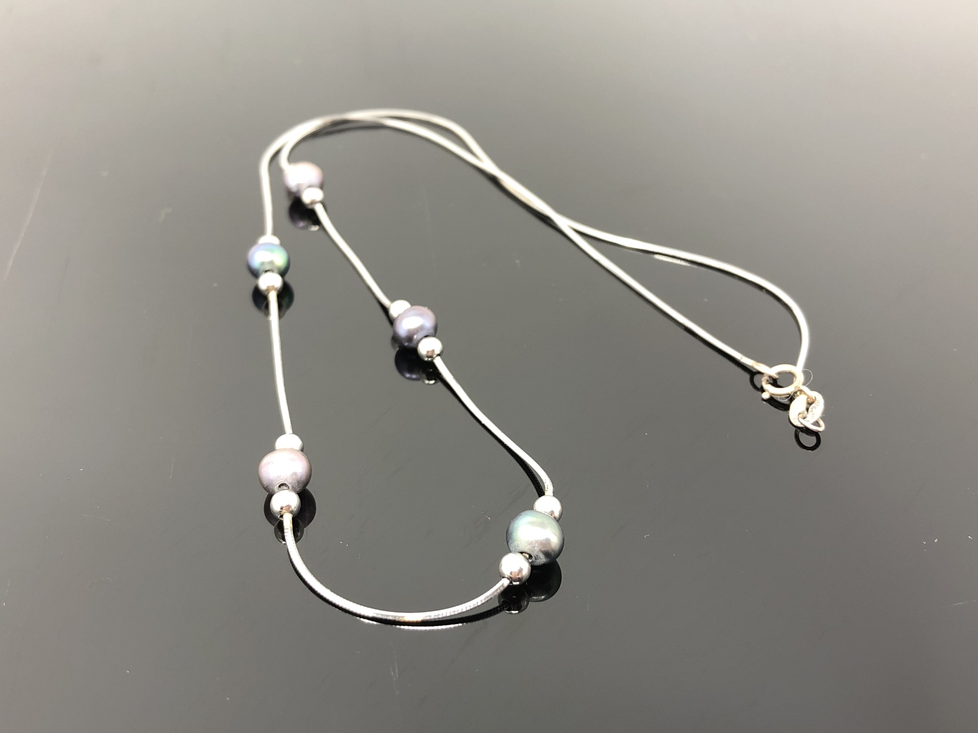 A 9ct white gold grey pearl necklace