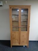 An Ikea pine double door bookcase