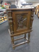 An early 20th century profusely carved cabinet on raised legs