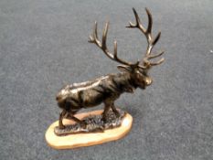 A cast iron figure - Stag on wooden plinth
