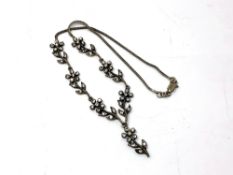 A decorative silver necklace
