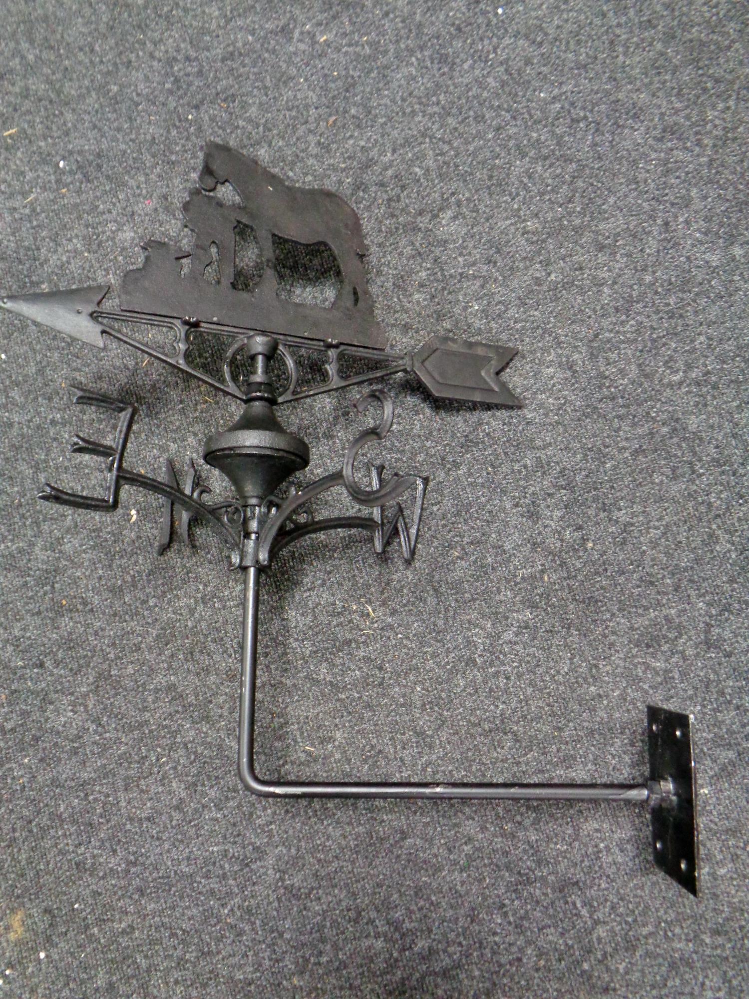 A cast iron blacksmith with horse weather vane