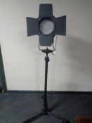 A theatre light on tripod stand