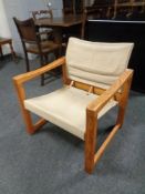 A 20th century pine armchair upholstered in canvas