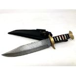 A Bowie knife with Damascus steel blade, camel bone and buffalo horn grip with brass mounts,