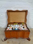 A twentieth century pine sewing box with lift out tray and contents bearing swastika emblem