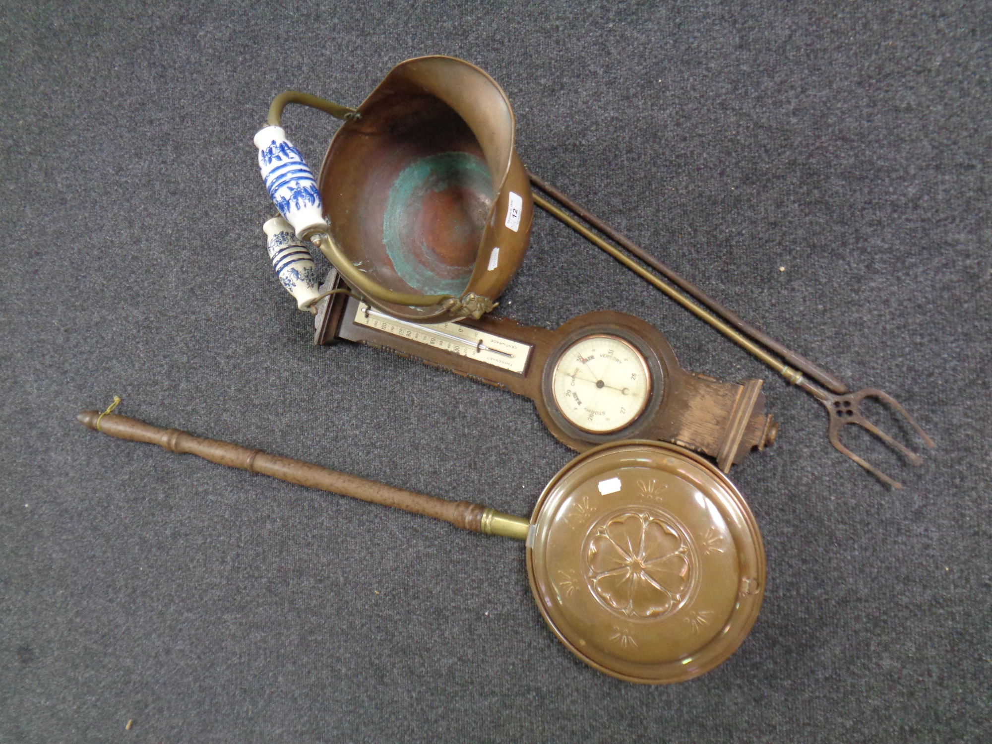 A copper and brass porcelain handled coal bucket together with a fire poker and toasting fork,