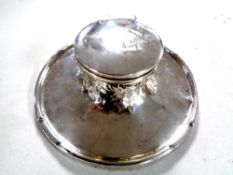 A silver inkwell,