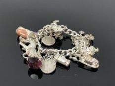 A heavy silver charm bracelet CONDITION REPORT: 96g