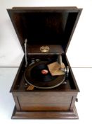 An antique oak cased Colombia Grafonola together with a box containing a quantity of vinyl 78