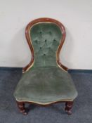 A Victorian mahogany lady's chair in buttoned upholstery