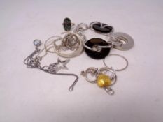 A collection of silver pendants,