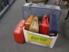 A box containing a quantity of assorted suitcases, leather briefcase,