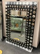 A contemporary mirror with circular mirrored frame,