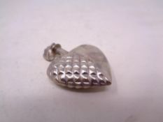 A silver perfume bottle pendant