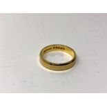 An 18ct gold band ring, size N. CONDITION REPORT: 3.