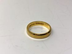 An 18ct gold band ring, size N. CONDITION REPORT: 3.