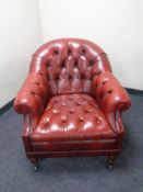 A red button leather Chesterfield armchair