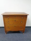 An early 20th century oak three drawer chest