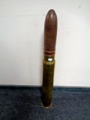 A brass ammunition shell casing with wooden point,