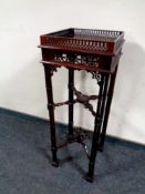 A reproduction Chippendale style fret work plant stand