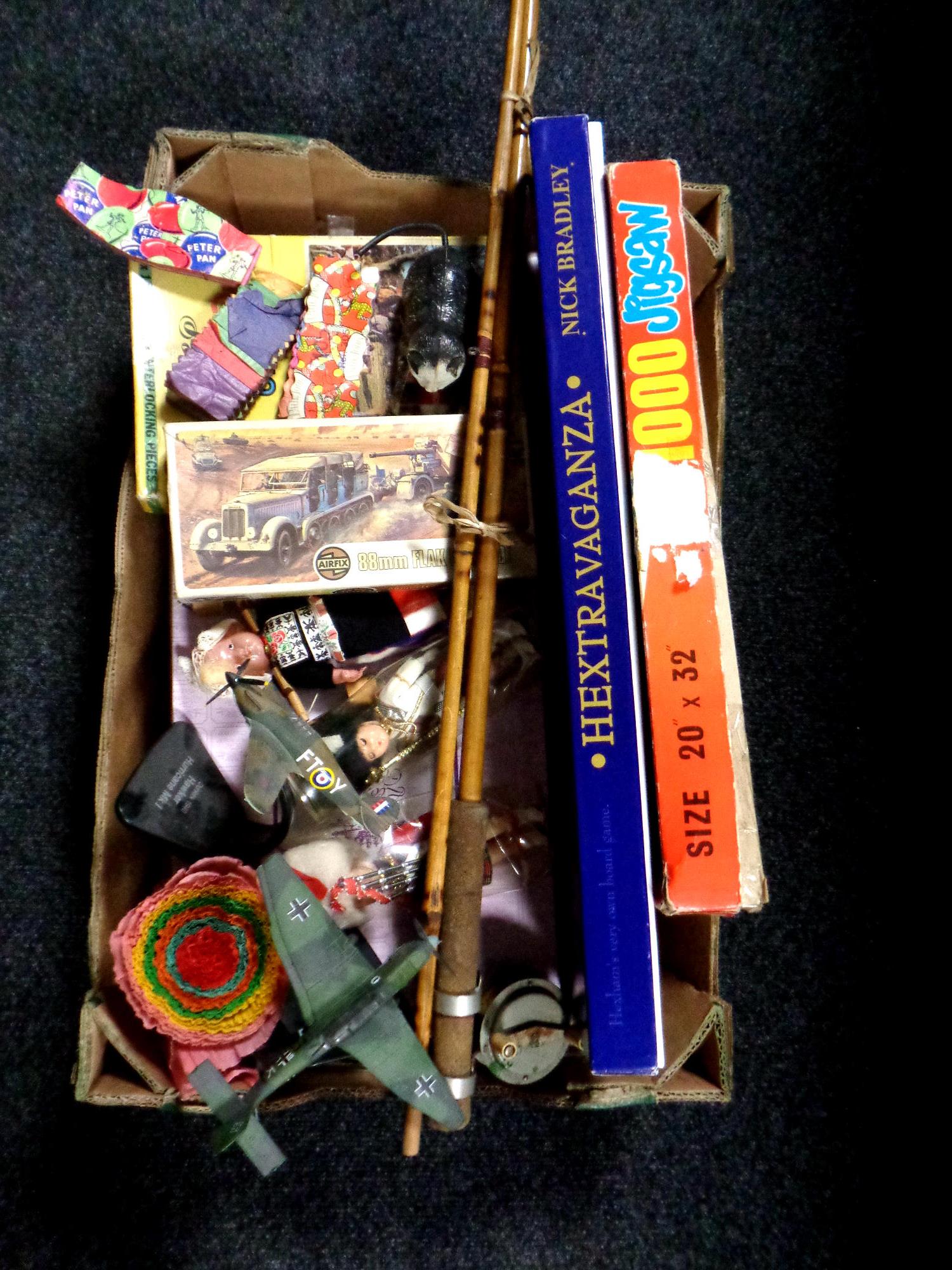 A box containing boxed doll, Airfix model kit, a three piece split cane fly rod with reel,