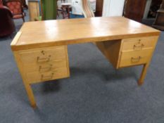 A 20th century teak twin pedestal desk fitted five drawers and two slides